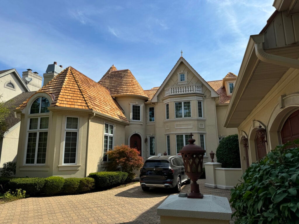 yellow residential house with cedar shake roof