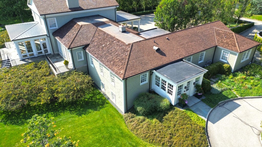 light green house with cedar shake roof