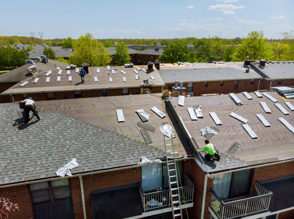 Construction worker on a renovation roof the house installed new shingles