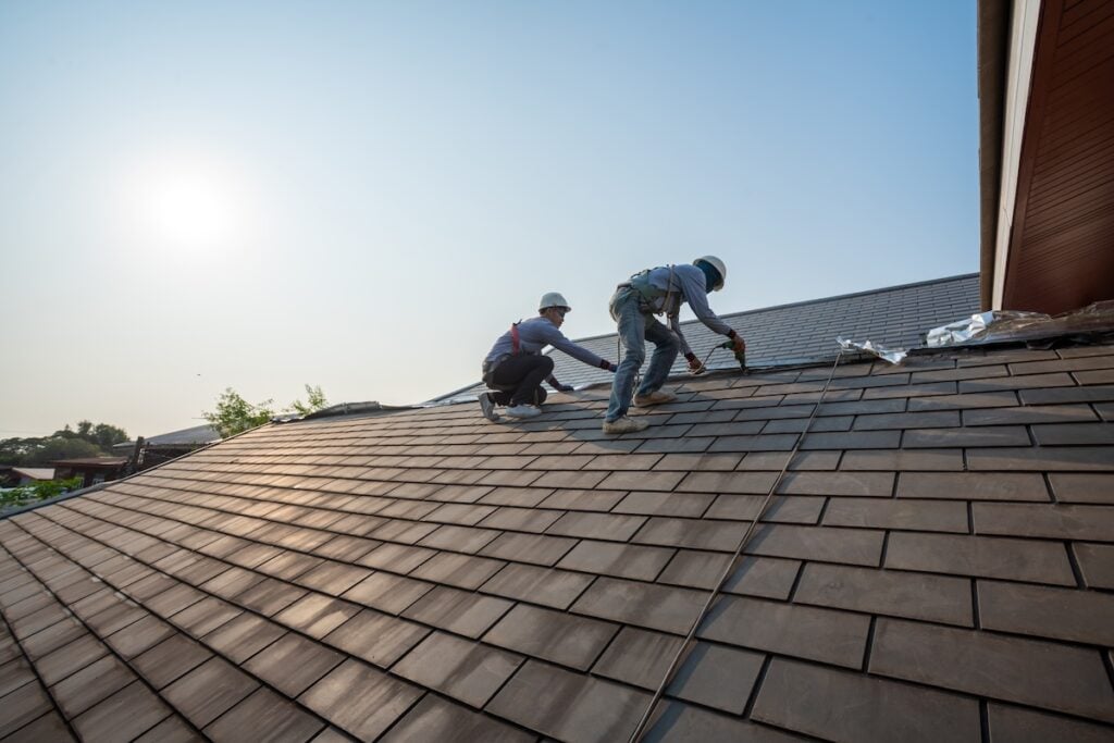 Roofer worker in special protective work wear and gloves