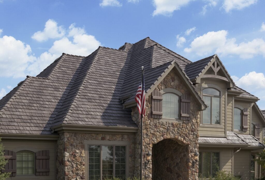 A large house with a new roof, a flag in front of the house