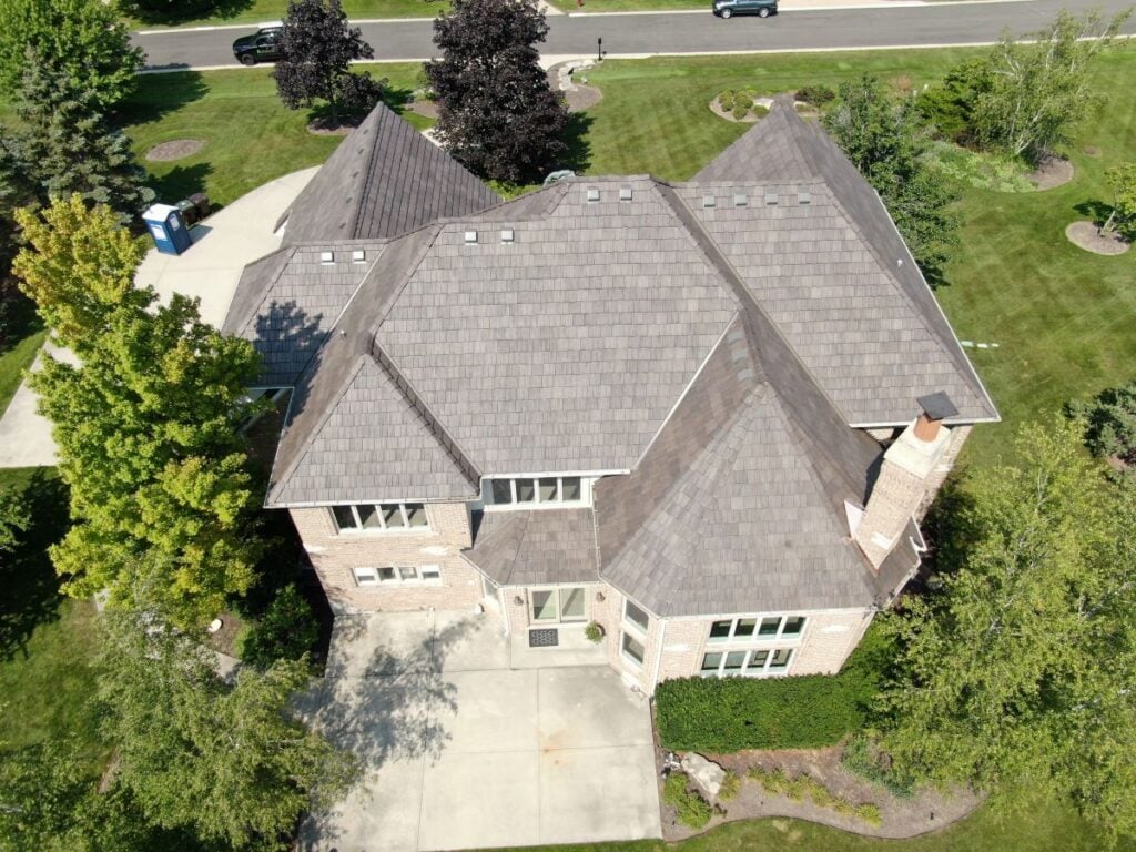 Aerial view of a house with a light gray slate roof