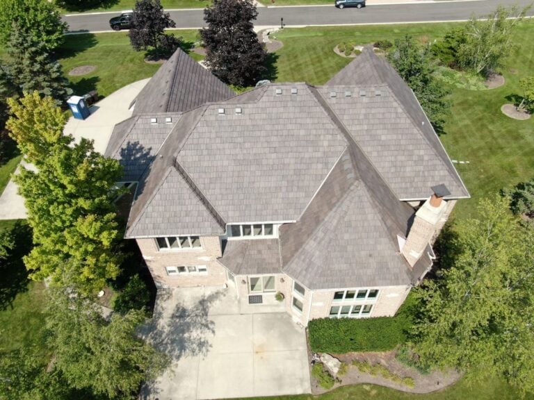 Aerial view of a house with a light gray slate roof