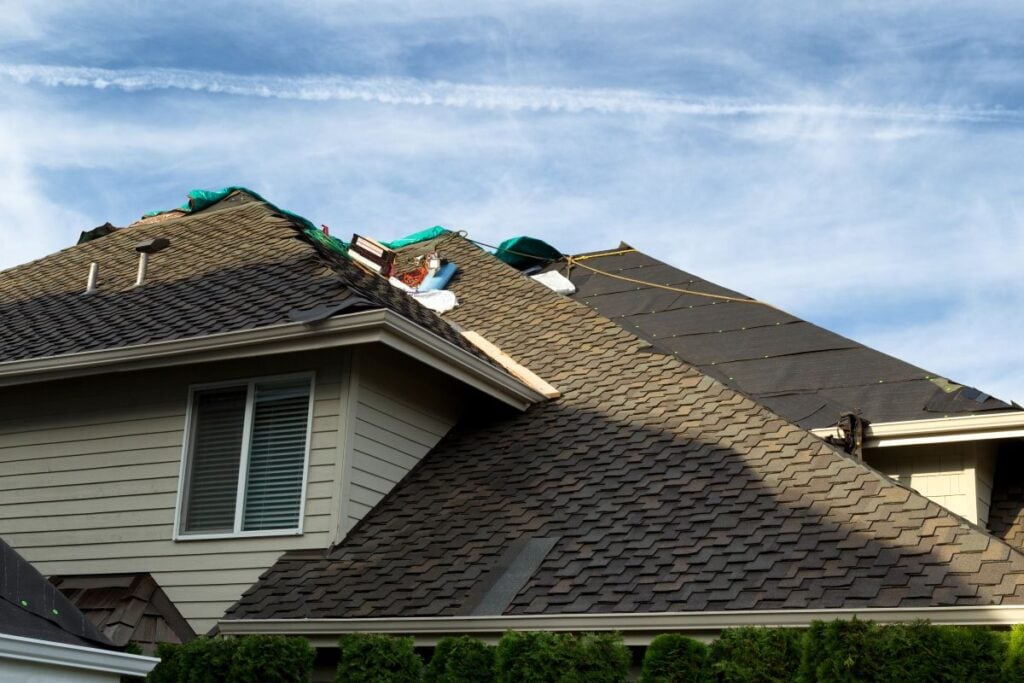 Home roof being replaced with new composite roofing materials