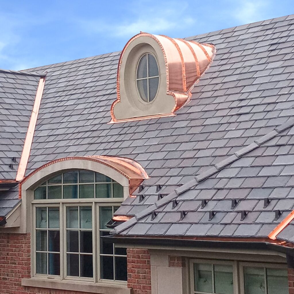 Composite shake roofing installed with copper accents