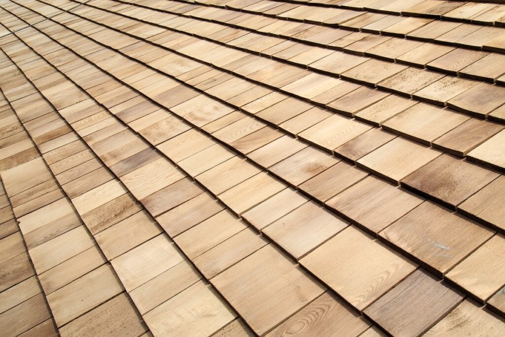 Composite wooden shake roofing material