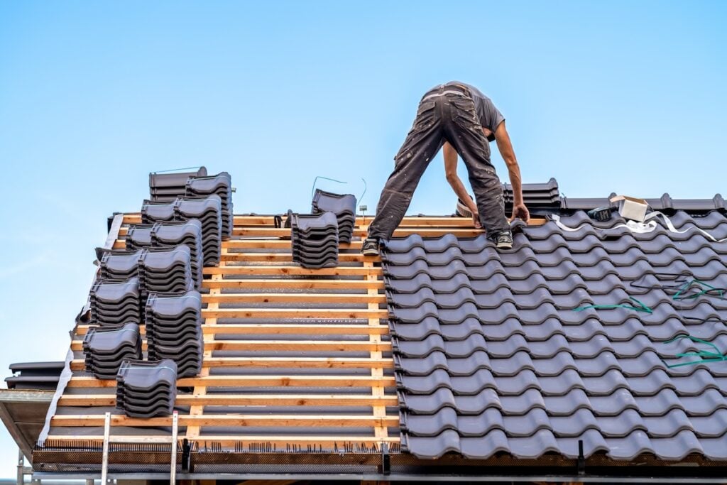 Composite shake roofing material being installed on home