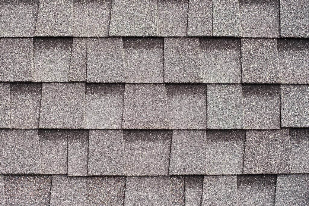 Gray shingles for covering the roof. Building material flexible tile background.
