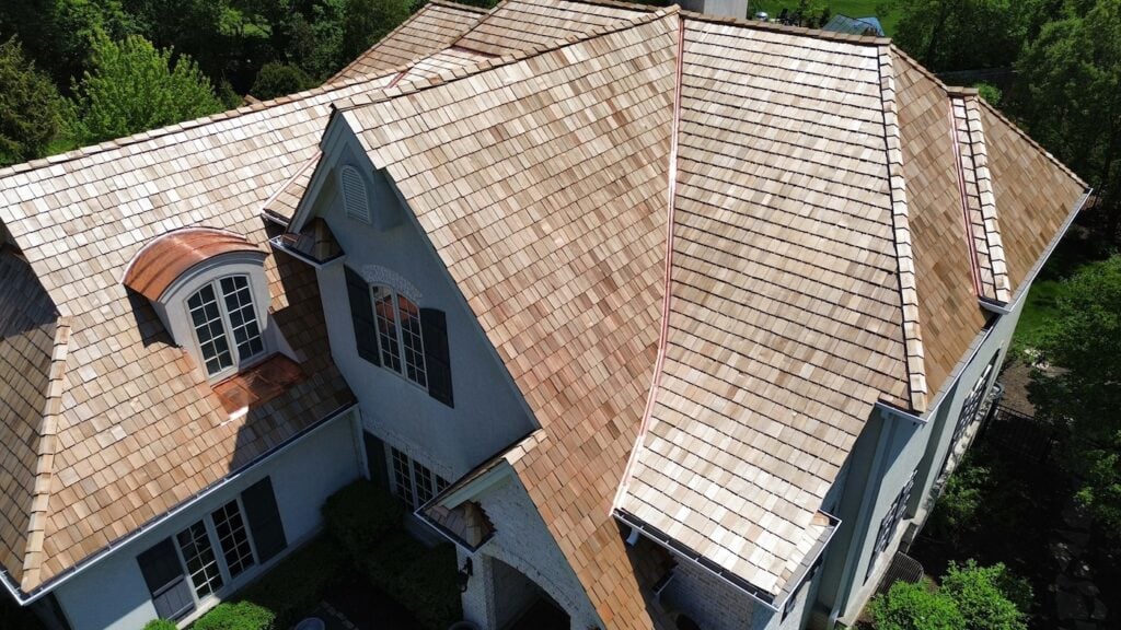 large white residential house cedar shake roofing and custom copper