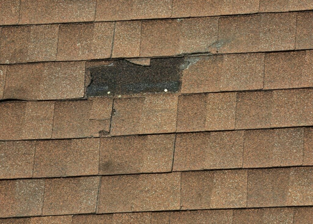 missing shingle on a brown shingle roof
