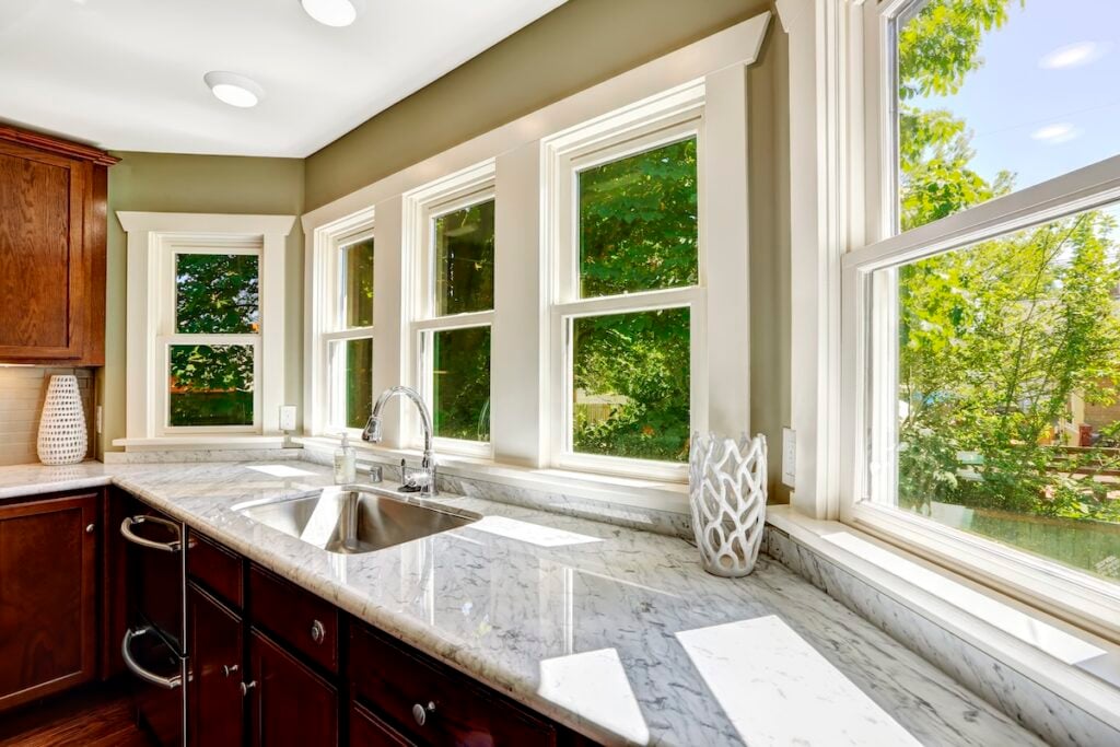 Beautiful kitchen cabinet with marble top and steel sink and new windows