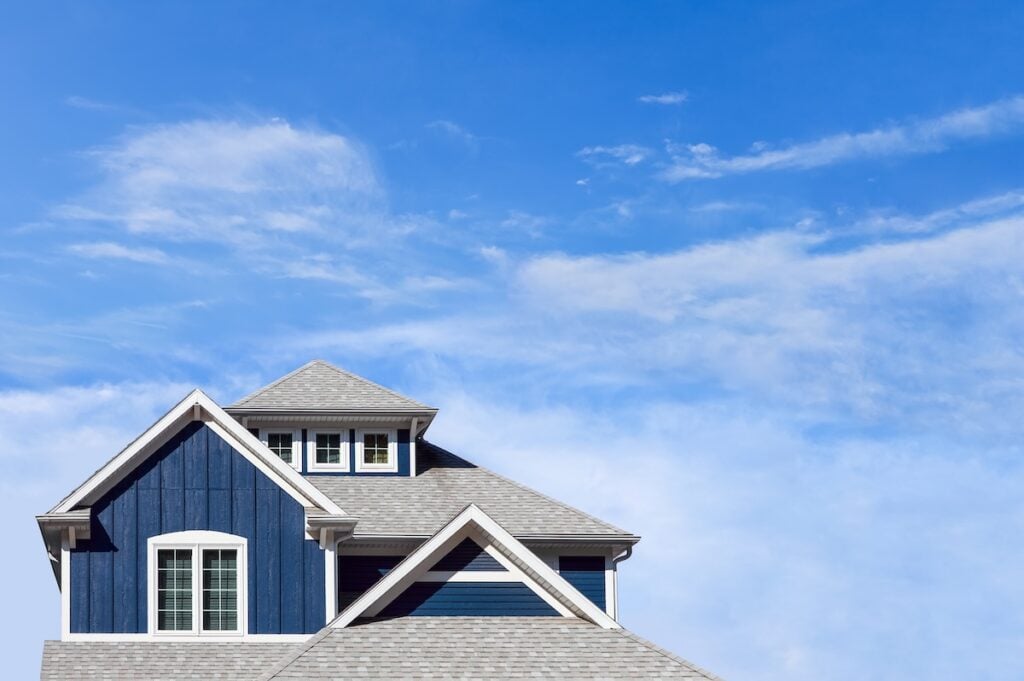 blue house with gray composite shingle roof
