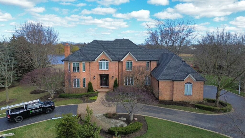 Brick house with a dark composite roof