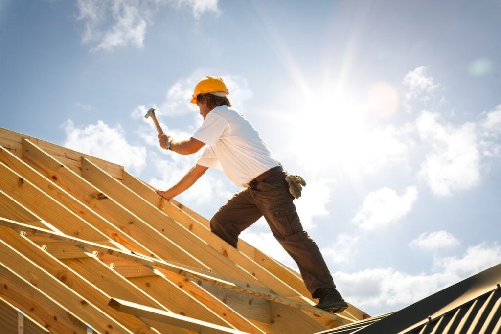 Roofer working on building a frame for a new house