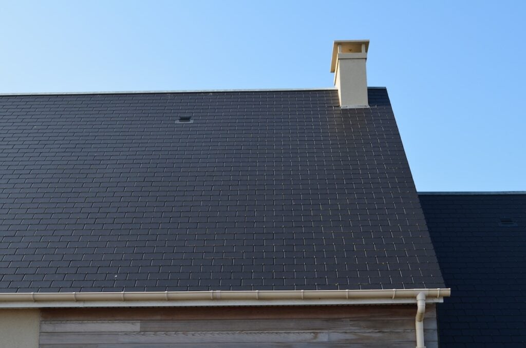 Black synthetic slate roof tiles installed on roof