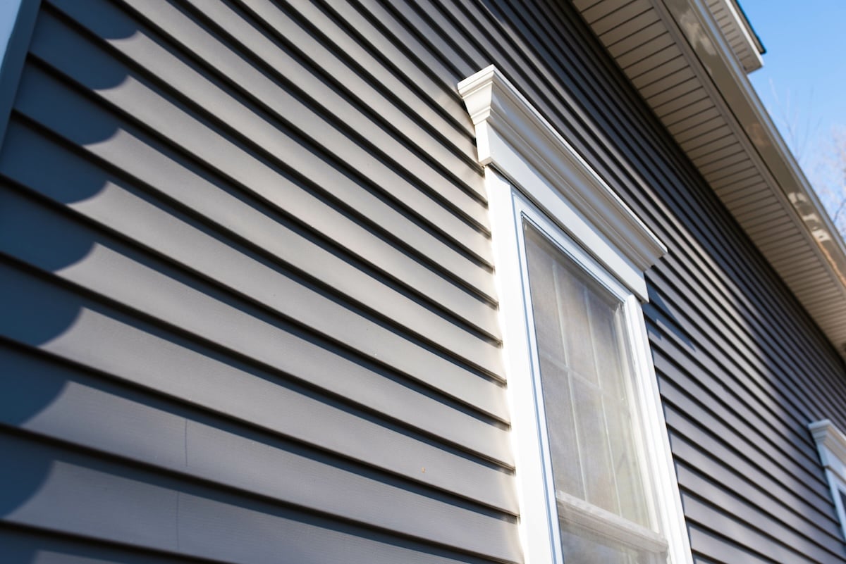 Dark vinyl siding in residential neighborhood, new window treatments